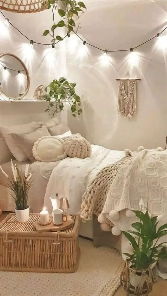 a white aesthetic bedroom for girls with fairy lights and some plants