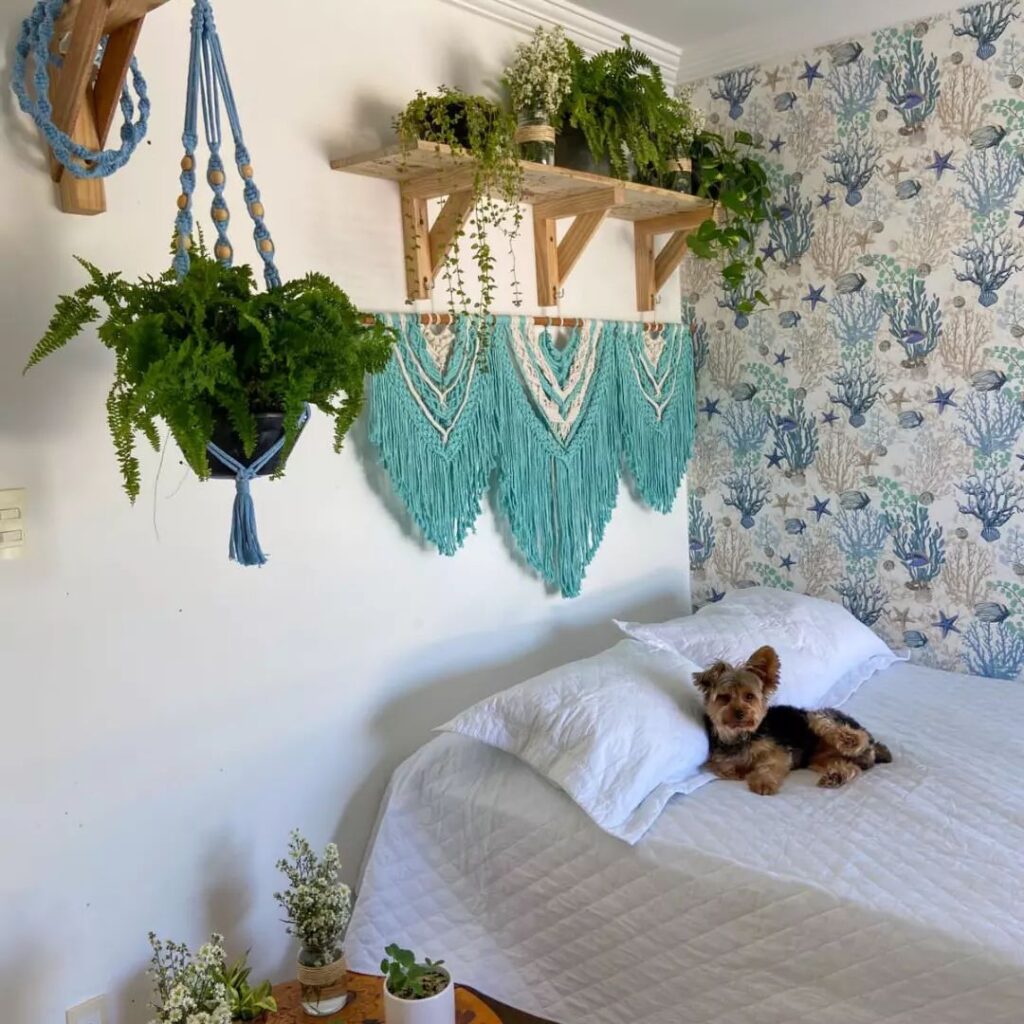 boho bedroom with printed wall, floating shelves, plants and macrame wall hanging
