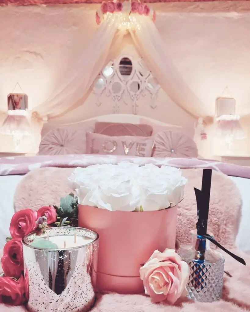 a pink fairy bedroom with candles and flowers