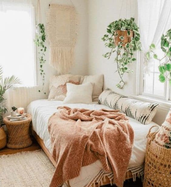 girly boho bedroom with plants and macrame