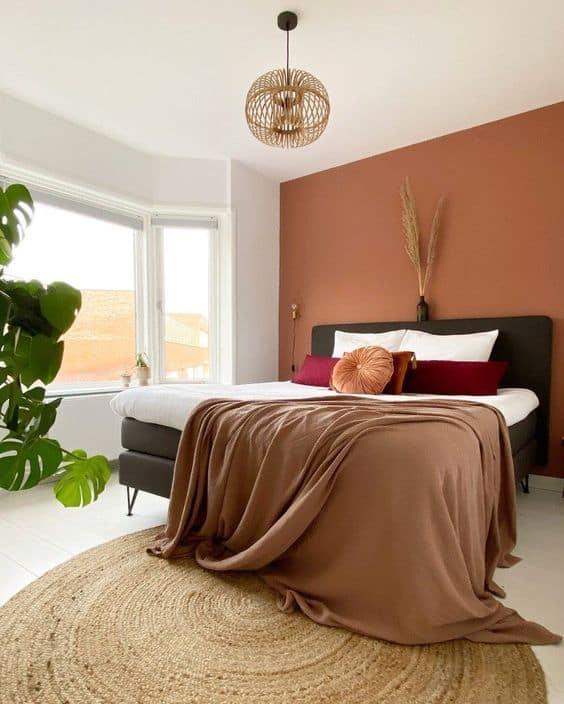 bedroom with terracotta accent wall