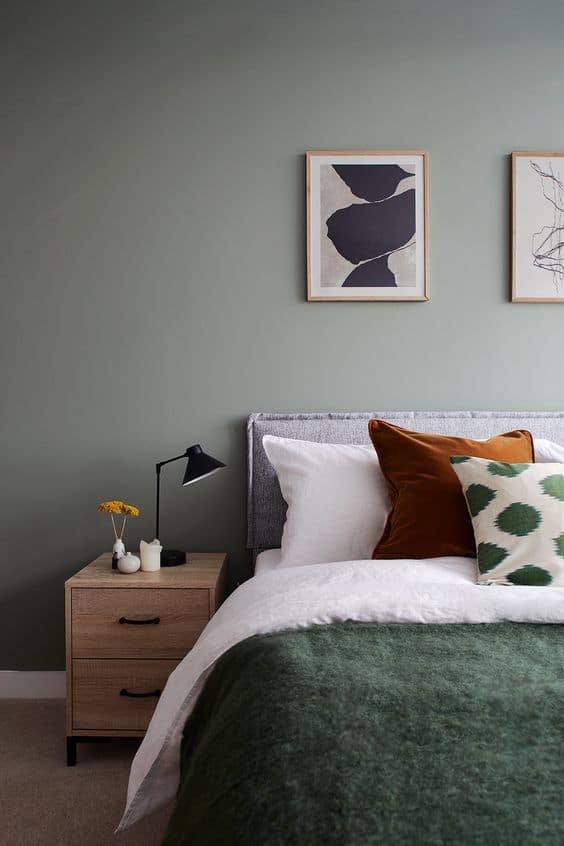 minimalist sage green bedroom with nightstand