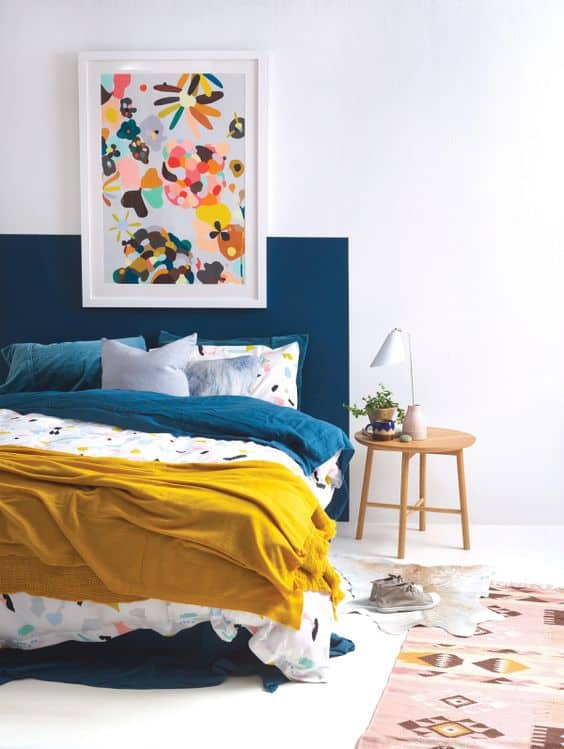 navy and mustard bedroom with wall art