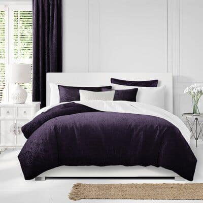 white bedroom with eggplant bedding