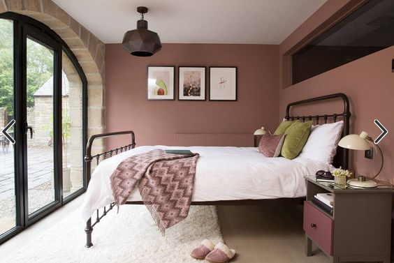 dusty pink walls and white bed