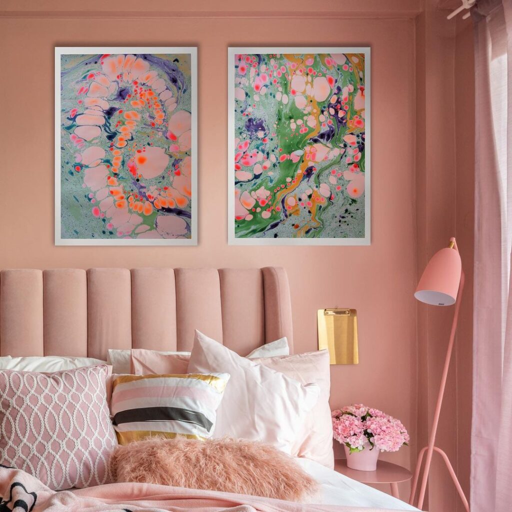 monochrome pink bedroom with colorful wall art