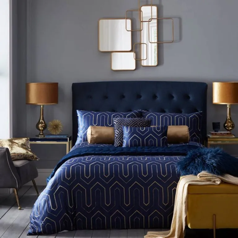 navy bed and golden lamps