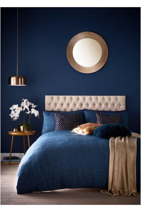 navy bedroom with golden accents
