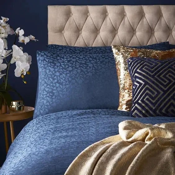 navy blue bed with gold pillow