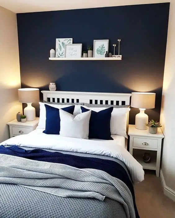navy blue bedroom with golden lamps