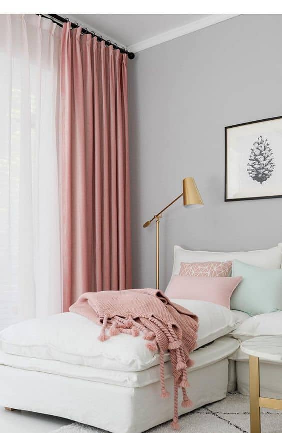 grey and white bedroom with pink curtains