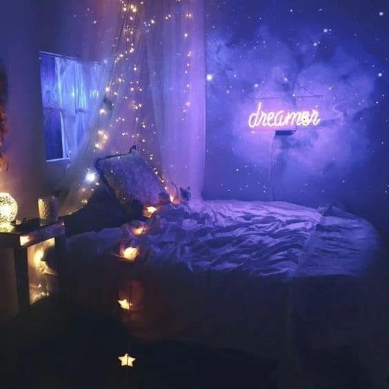 a galaxy bedroom with neon signs