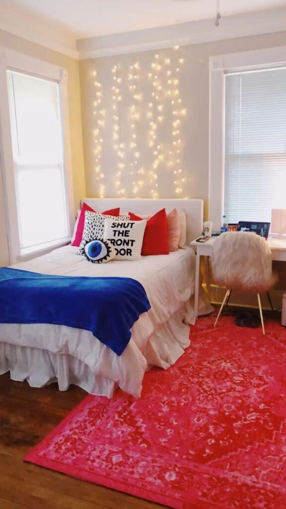 white bedroom with red and bl;ue