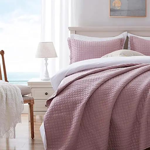 mauve bedding in a neutral-color room