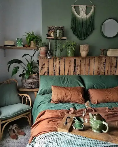 green bedroom with plants on the headboard