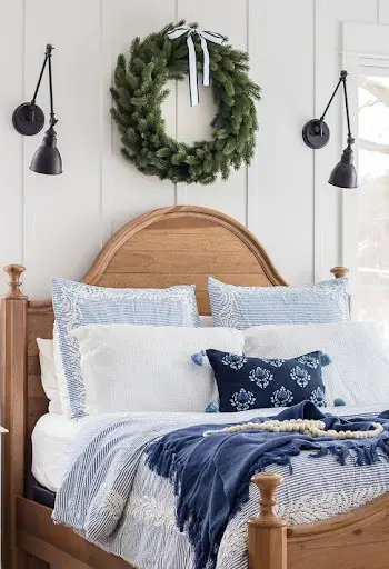 white and blue bedroom with green christmas wreath