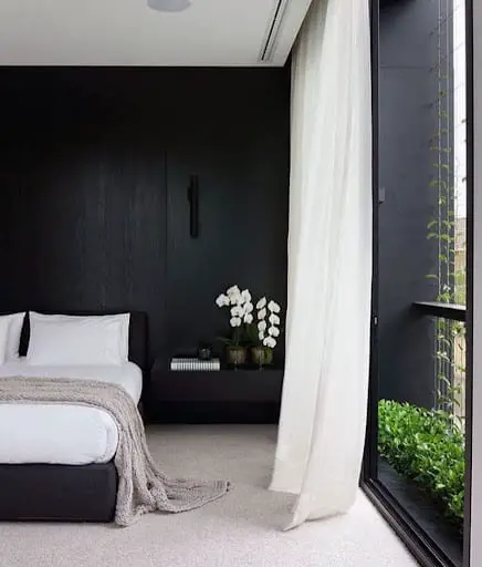 modern bedroom with black accent wall