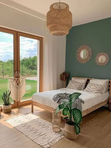 boho bedroom idea with green accent wall