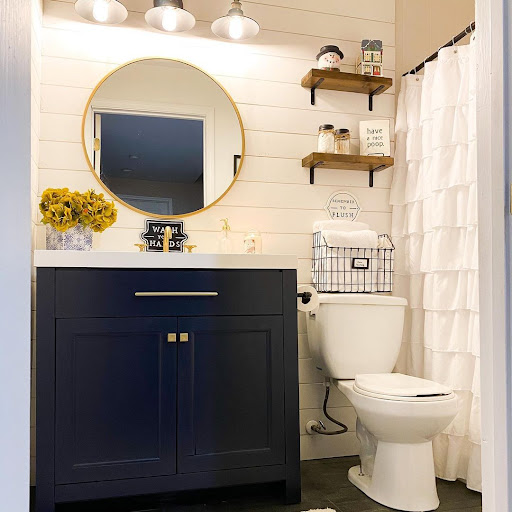 blue cabinet in shiplap bathroom