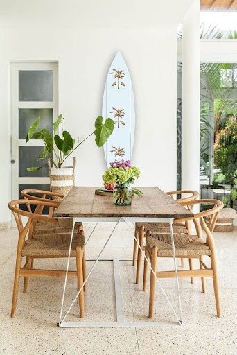 coastal dining room idea with surfboard wall decor