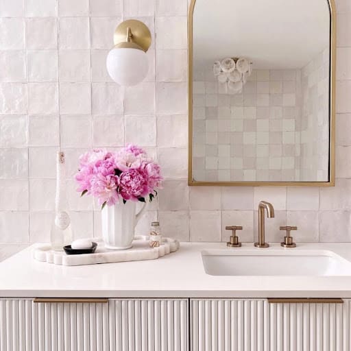 textured pink bathroom backsplash