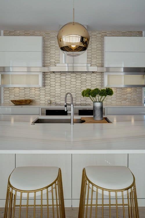 white kitchen with gold tile backsplash