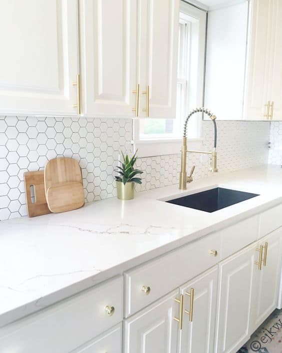 white kitchen with gold accessories