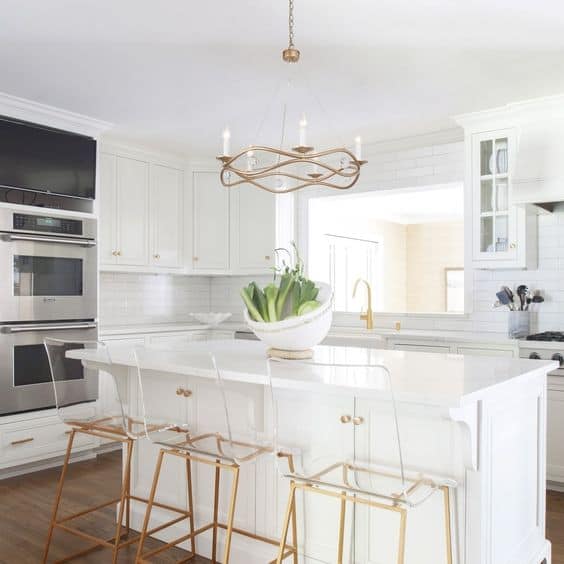 white and gold kitchen with chandelier