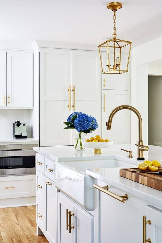 white and gold kitchen with flowers