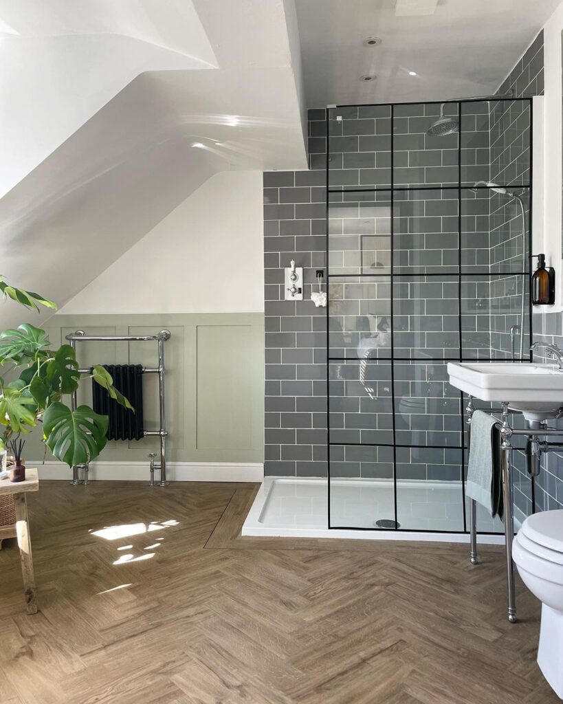 sage green bathroom with wooden flooring