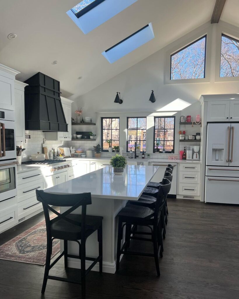 vaulted ceiling in the dining room with skylights